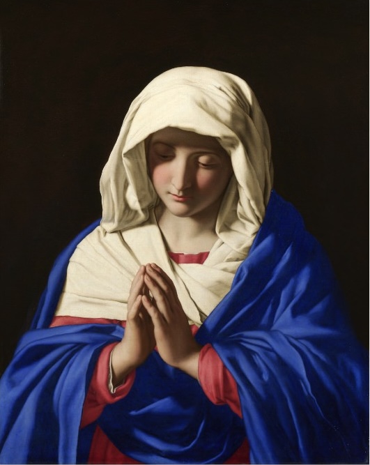 Classical painting of the Virgin Mary with hands clasped in prayer, wearing a blue robe and white head covering